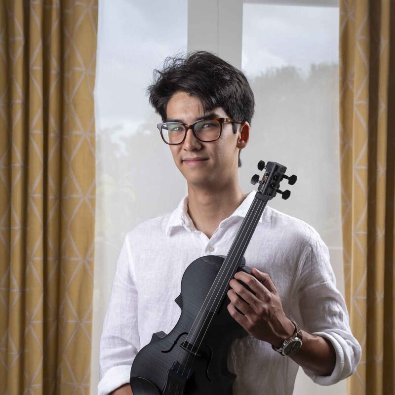 Ethan Tieu with one of his 3D-printed violins.