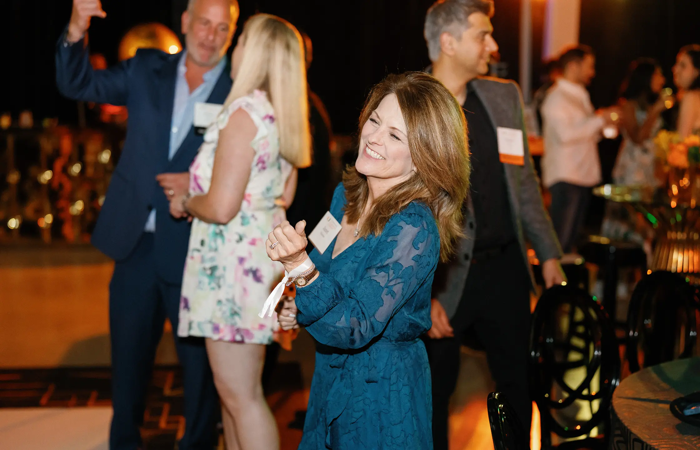 woman smiling at alumni reunion event