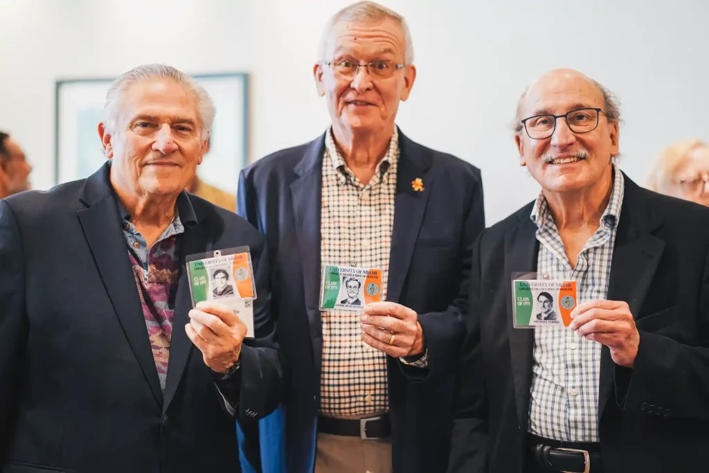 Class of 1975 alumni, from left, Abilio Coello, M.D., Lewis Dean Hoover, M.D., and Michael Norris, M.D., posing with their yearbook photos.